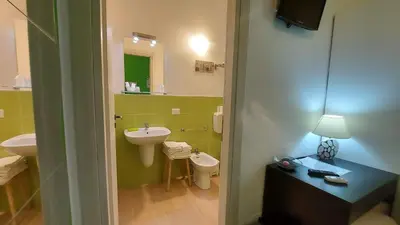 a bathroom with a sink and a toilet and a mirror at La Suite Di Segesta in Calatafimi