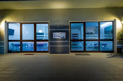 an empty building with glass doors and windows at night at Le Camere del Crimiso in Castellammare del Golfo