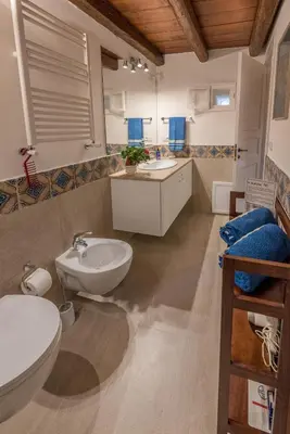 a bathroom with two sinks and two toilets at Il Glicine La Piana dei Colli in Mondello