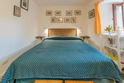 a bedroom with a bed with a blue comforter at Il Glicine La Piana dei Colli in Mondello