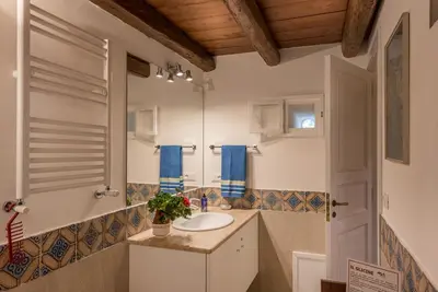 a bathroom with a sink and a mirror at Il Glicine La Piana dei Colli in Mondello