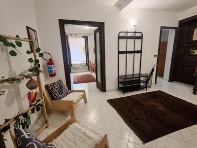 a room with two beds and a table in it at 4 passi Casa Vacanza in Palermo