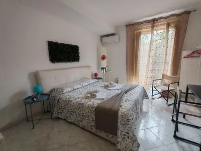 a bed in a room with a large window at 4 passi Casa Vacanza in Palermo