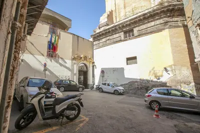 a motorcycle parked in a parking lot next to a building at Storie di Palermo in Palermo
