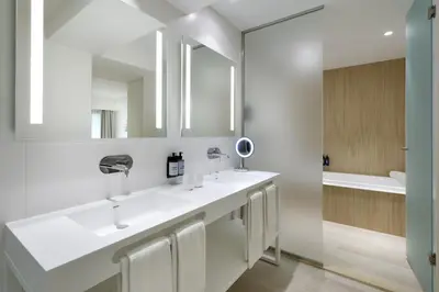 a bathroom with two sinks and a mirror at The Signature Level at Grand Palladium Sicilia Resort & Spa in Campofelice di Roccella