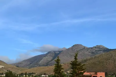 a view of a mountain range with clouds in the sky at La Giara San Vito Lo Capo in Castelluzzo