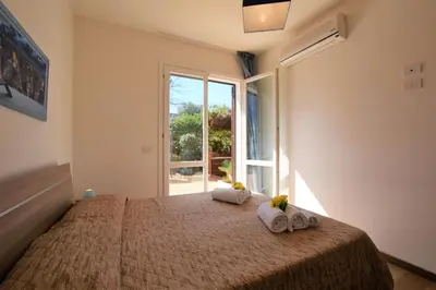 a bedroom with a bed with towels and a window at Casa Vacanza Azzurra in San Vito lo Capo