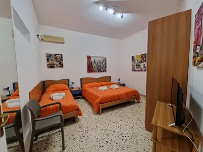 a bedroom with two beds and a flat screen tv at Mondello vista in Mondello