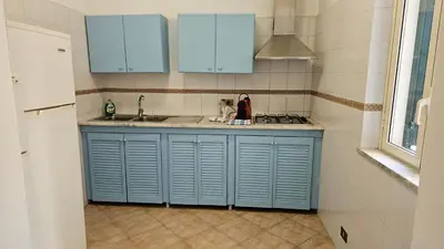 a kitchen with blue cabinets and a sink at Mondello vista in Mondello