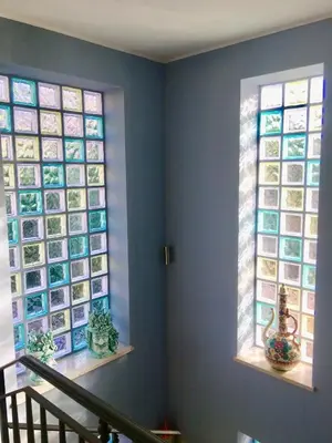 a room with two windows with pictures on the wall at Casa vacanze Isolotto in Isola delle Femmine