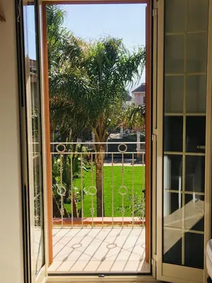 an open sliding glass door with a view of a yard at Casa vacanze Isolotto in Isola delle Femmine