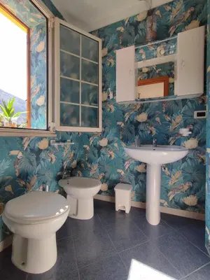 a bathroom with a toilet and a sink at Casa vacanze Isolotto in Isola delle Femmine