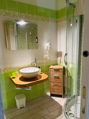 a bathroom with a sink and a shower at Triskell Camere & Relax in Castelluzzo