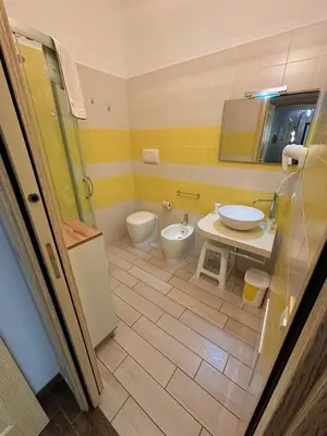 a bathroom with a sink and a toilet and a shower at Triskell Camere & Relax in Castelluzzo