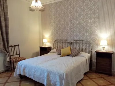 a bedroom with a bed with a blue blanket at Villa Calcasacco in Termini Imerese