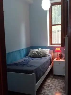 a bedroom with a bed and a window at Villa Calcasacco in Termini Imerese