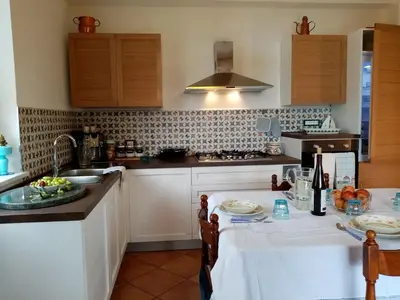 a kitchen with a table and a sink at Villa Calcasacco in Termini Imerese
