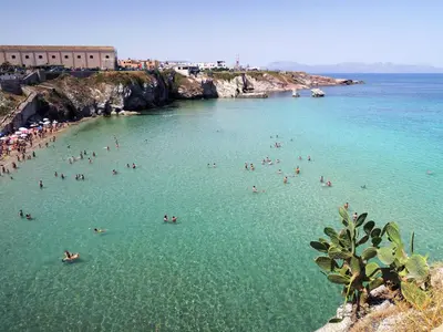 a group of people in the water at a beach at TerraSole Bakery B&B in Terrasini