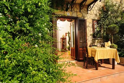 a table with a yellow table cloth sitting on a patio at Villa Dafne in Alia