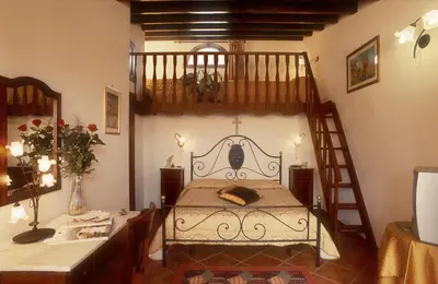 a bedroom with a bunk bed with a ladder at Villa Dafne in Alia