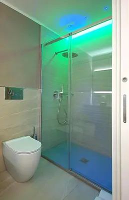 a bathroom with a glass shower with a toilet at BURNÌA Sicily Holiday House in Palermo
