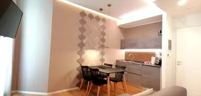 a kitchen with a table and chairs in a room at BURNÌA Sicily Holiday House in Palermo