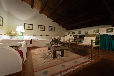 a living room with a bed and a table and chairs at Masseria Pernice in Monreale