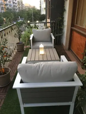 a white couch sitting on a balcony with a table at Maison de Famille in Palermo