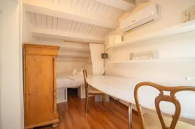 a small room with a table and a bed at Solemar Sicilia - Casa Olivia in Santa Flavia