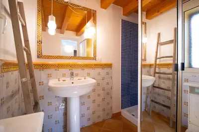 a bathroom with a sink and a mirror at Solemar Sicilia - Casa Olivia in Santa Flavia