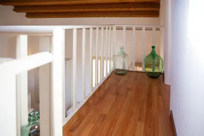 two green glass vases sitting on a wooden floor at Solemar Sicilia - Casa Olivia in Santa Flavia
