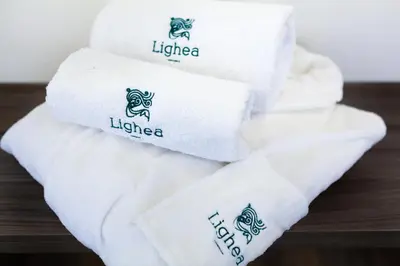 a pile of white towels sitting on a table at Lighea aqua suites and breakfast in Palermo