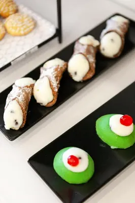a row of sushi on a black plate at Lighea aqua suites and breakfast in Palermo