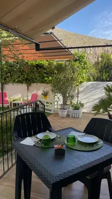 a table with plates of food on a patio at Alemar Bed & Breakfast in Mondello