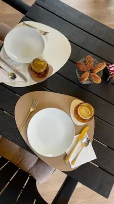 a table with white plates and utensils on it at Alemar Bed & Breakfast in Mondello