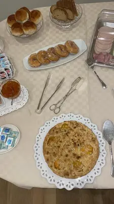 a table topped with a plate of bread and pastries at Alemar Bed & Breakfast in Mondello
