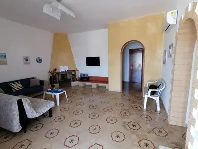 a living room with a couch and a tv at Villa Giulia in Alcamo Marina