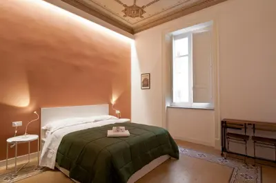 a bedroom with a bed and a window at Palazzo Amazigh in Palermo