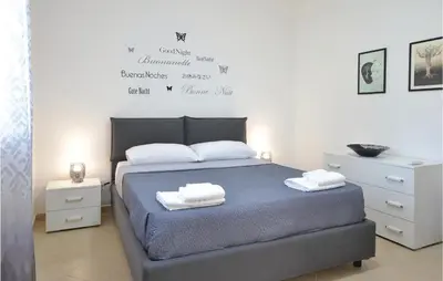 a bedroom with a bed with two towels on it at Appartamento Darling in Isola delle Femmine