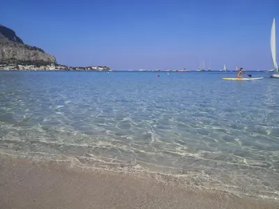 a person on a surfboard in the water at the beach at VILLA LEA in Mondello