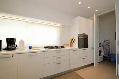 a kitchen with white cabinets and a stove at La Dimora di Venere in Alcamo