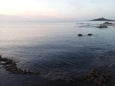 a view of the ocean with rocks in the water at Casa Vacanze Laura in Isola delle Femmine