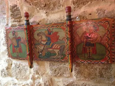 a wall with mosaics on the side of a building at B&B Domus Dei Cocchieri in Palermo