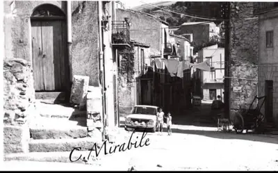 an old photo of a car parked in an alley at DREAM CORLEONE in Corleone