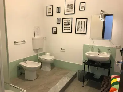 a bathroom with a toilet and a sink at Casa Helios in Castellammare del Golfo