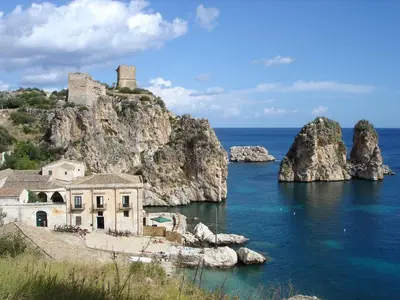 an old house on a rocky island in the ocean at Casa Helios in Castellammare del Golfo