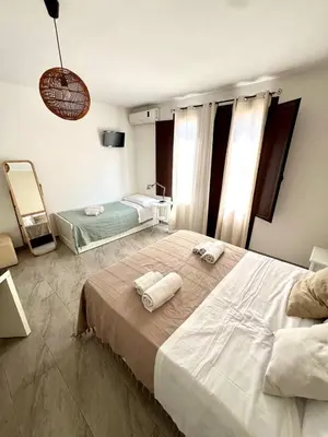 a bedroom with two beds with towels on them at Casa Helios in Castellammare del Golfo