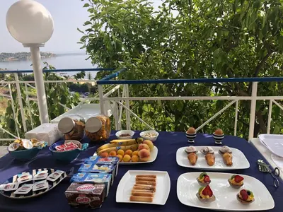 a blue table with plates of food on it at Blue Island Villa Caterina in Casteldaccia