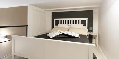a white bed with two pillows on top of it at SpasimoH-3 in Palermo