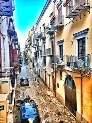 a street with buildings and a car parked on the street at SpasimoH-3 in Palermo